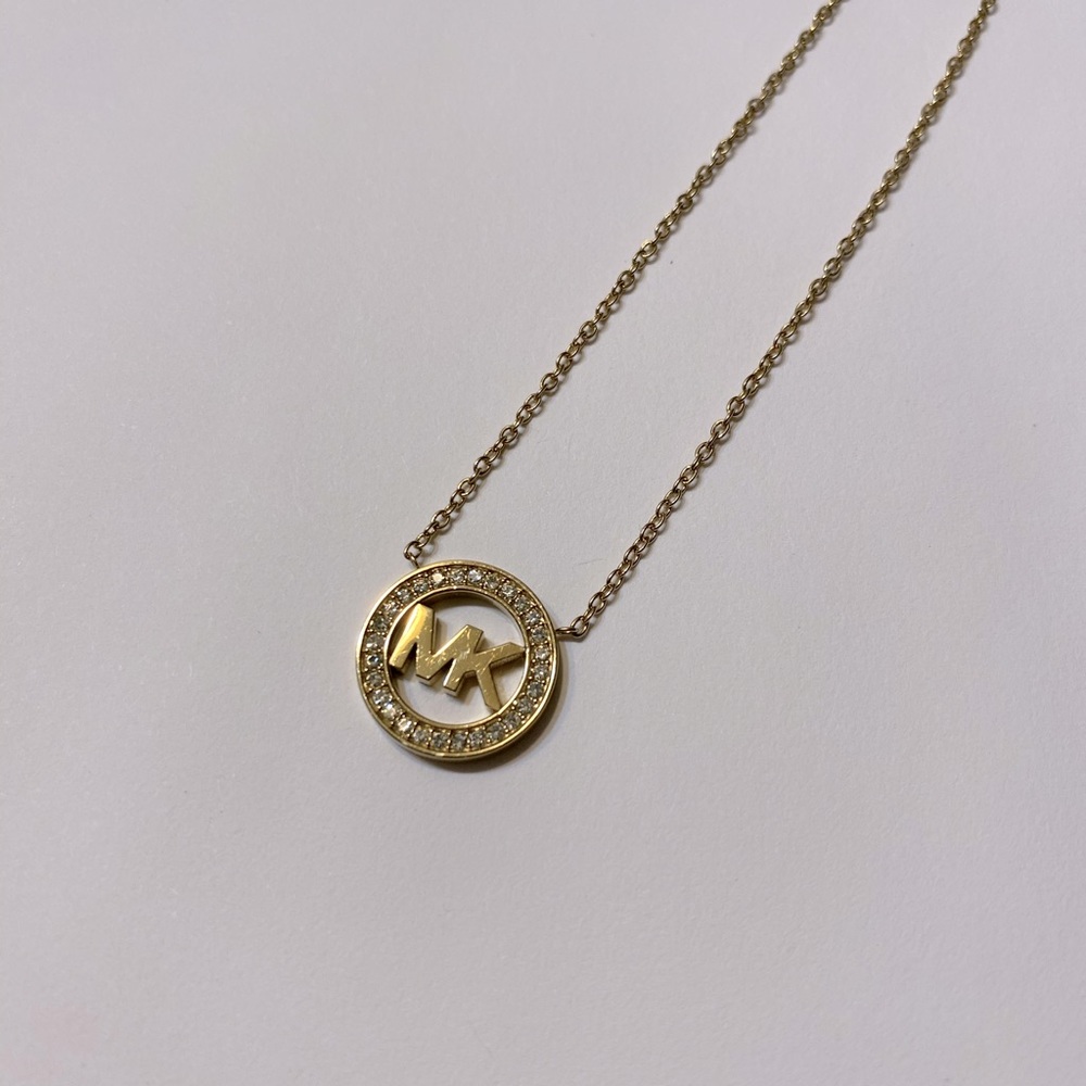 Michael Kors gold necklace and matching earrings.